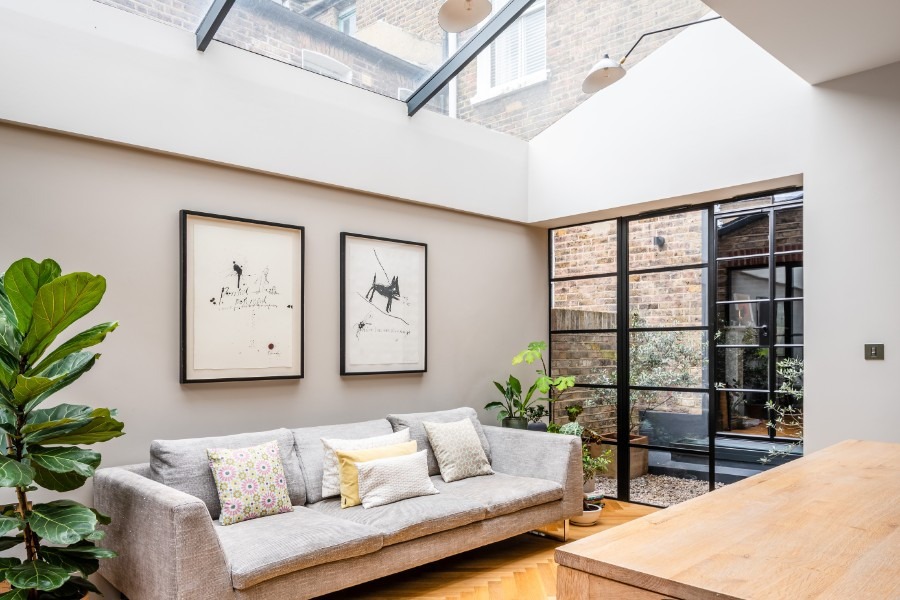 Finished London basement living space by UHM Basements, natural light and refined joinery